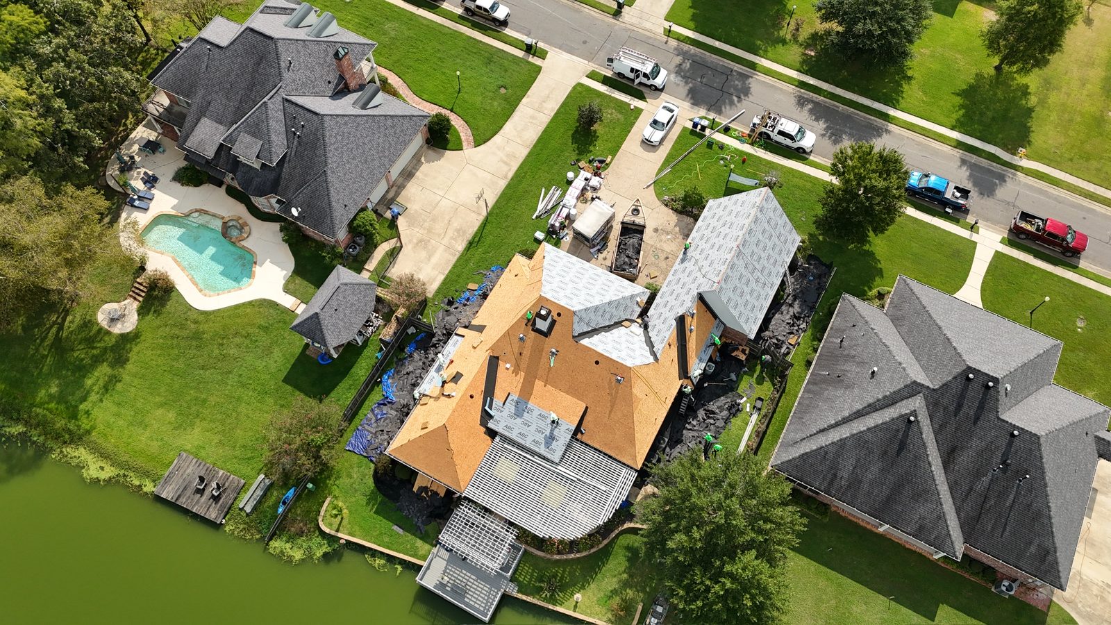 Aerial view of a roof replacement on a lakefront home in Shreveport-Bossier City