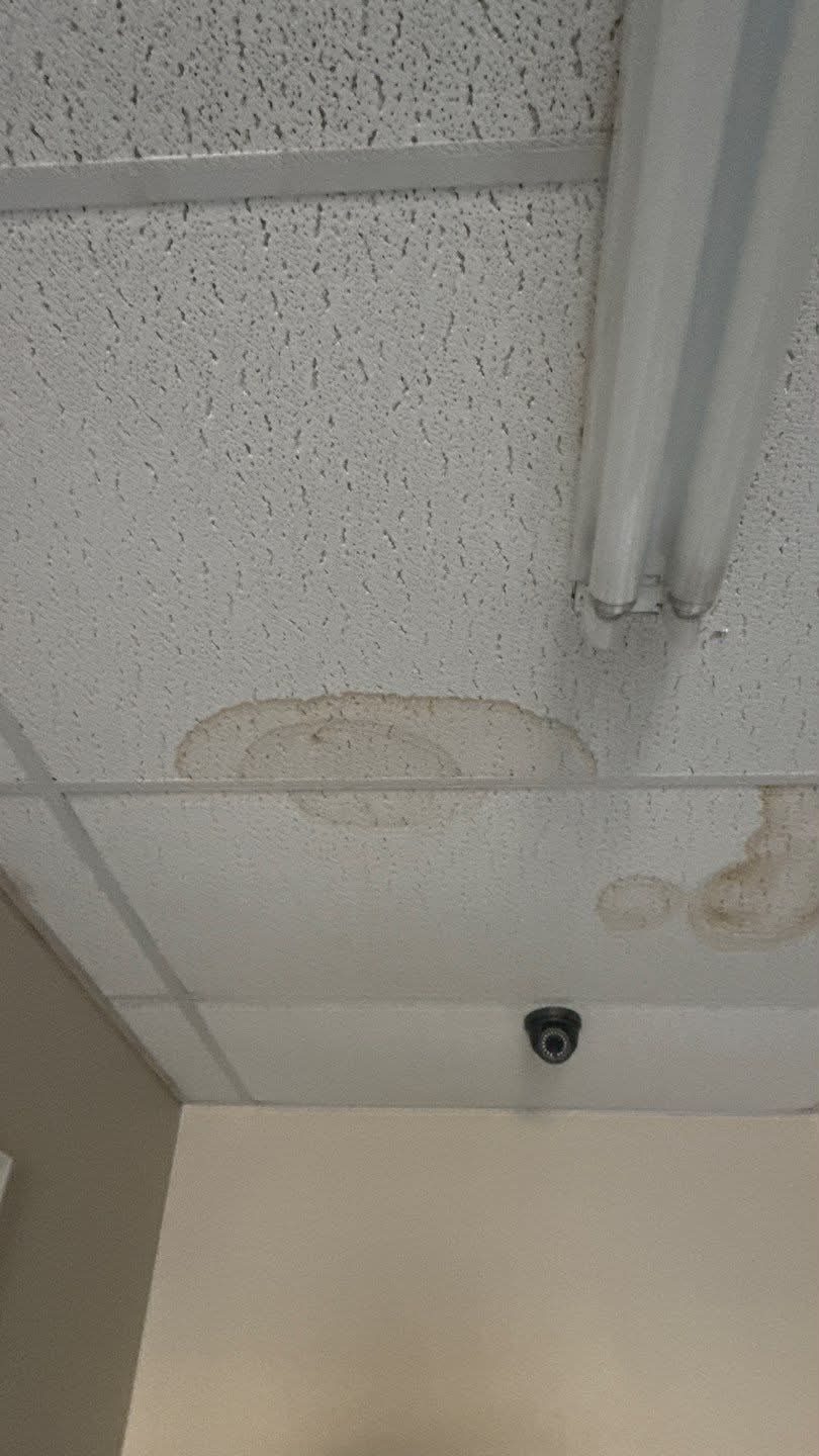Water-damaged ceiling tiles caused by a roof leak in Bossier City