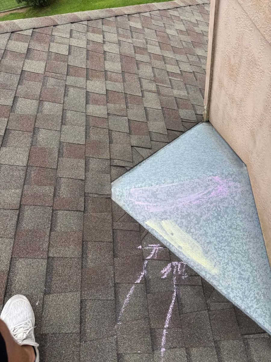 Hail marks on metal flashing highlighted with chalk on a Shreveport roof