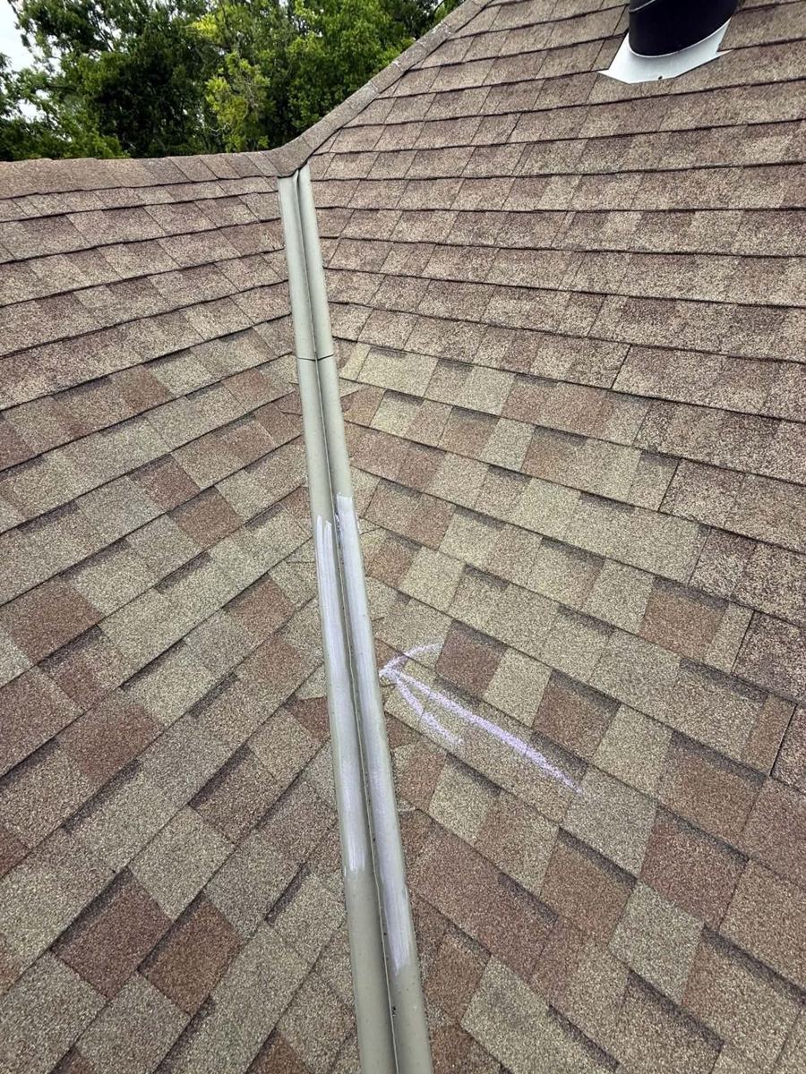 Hail dents on roof valley metal marked with chalk on a Shreveport home