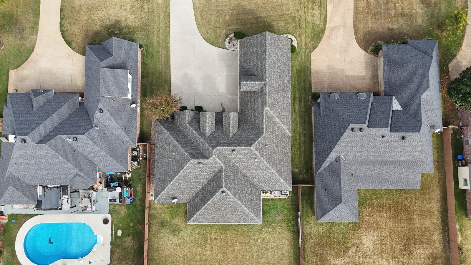 New roof on a brick home with backyard greenhouse in Shreveport-Bossier City