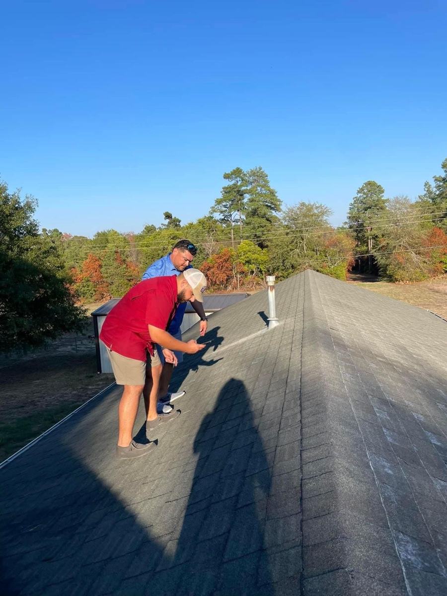 Indemnity Roofing inspector meeting an insurance adjuster on a roof in Shreveport to document storm damage
