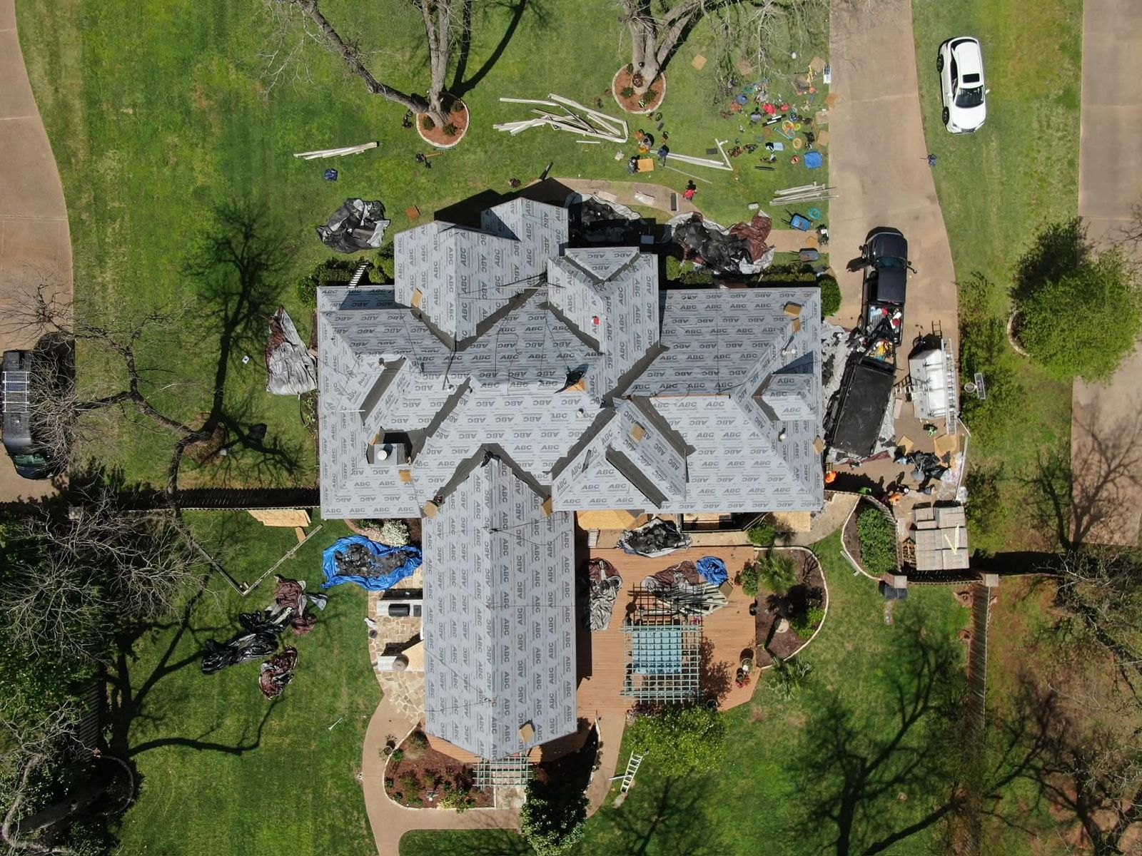Aerial view of a Shreveport home during roof replacement with new underlayment installed
