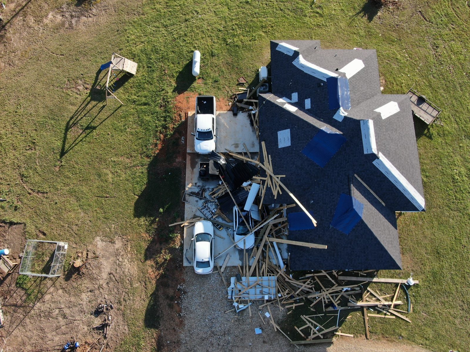 Roof replacement in progress showing tear-off and decking with crew working in Shreveport-Bossier City